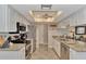 Bright kitchen showcases granite countertops, stainless appliances, and white cabinetry at 1048 Ulrey Ln, Englewood, FL 34223