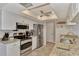 Bright kitchen features stainless steel appliances, granite counters, tile backsplash and ceiling fan at 1048 Ulrey Ln, Englewood, FL 34223