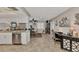 Open-concept kitchen and dining area with white cabinets, granite counters, and stainless steel appliances at 1048 Ulrey Ln, Englewood, FL 34223