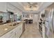 Kitchen opens to living spaces and features granite counters, stainless appliances and white cabinetry at 1048 Ulrey Ln, Englewood, FL 34223