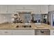 Kitchen island features granite counters and stainless dishwasher, conveniently located next to dining area at 1048 Ulrey Ln, Englewood, FL 34223