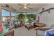 The screened patio offers ample seating and views of the home's backyard and canal at 1048 Ulrey Ln, Englewood, FL 34223