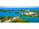 Majestic aerial view of the coastal neighborhood featuring island homes connected by a bridge at 109 Bayshore Rd # 10, Nokomis, FL 34275
