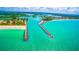 Breathtaking aerial view featuring a scenic pier, sandy beaches, and clear turquoise water at 109 Bayshore Rd # 10, Nokomis, FL 34275