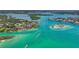 Captivating aerial view featuring waterfront homes, boats cruising through the crystal clear turquoise water at 109 Bayshore Rd # 10, Nokomis, FL 34275