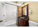 Bright bathroom featuring a shower-tub combo, elegant vanity, and dark countertop at 109 Bayshore Rd # 10, Nokomis, FL 34275