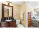 Bathroom with elegant vanity, dark countertop, and a bedroom view at 109 Bayshore Rd # 10, Nokomis, FL 34275