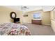 A large bedroom with a ceiling fan, carpet, a double bed, and a sitting area at 109 Bayshore Rd # 10, Nokomis, FL 34275