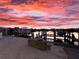 The property's private dock at sunset, perfect for boating and enjoying the serene waterfront atmosphere at 109 Bayshore Rd # 10, Nokomis, FL 34275