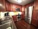 Kitchen with stainless steel appliances, granite countertops, and rich wood cabinets at 109 Bayshore Rd # 10, Nokomis, FL 34275