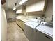 Spacious laundry room features a large sink, ample counter space, and washer/dryer at 109 Bayshore Rd # 10, Nokomis, FL 34275