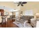 Cozy living room with a ceiling fan, and warm natural light throughout the open floor plan at 109 Bayshore Rd # 10, Nokomis, FL 34275