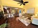 Open-concept living room flowing into the dining area, featuring hardwood floors at 109 Bayshore Rd # 10, Nokomis, FL 34275