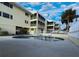 Community pool, next to the building, featuring lounge chairs and a pristine swimming area at 109 Bayshore Rd # 10, Nokomis, FL 34275