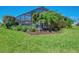 View of the backyard landscaping and the screened in patio at 11803 Sistine Ln, Venice, FL 34293