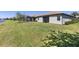 Expansive backyard features lush green grass and privacy, perfect for outdoor entertaining at 12565 Canavese Ln, Venice, FL 34293