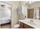 This bathroom has a wood vanity, tiled shower, and is conveniently located next to the bedroom at 12565 Canavese Ln, Venice, FL 34293