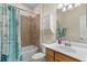 Charming bathroom with tile shower, bathtub, vanity, and updated fixtures, ready for relaxation at 12565 Canavese Ln, Venice, FL 34293