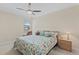 Comfortable bedroom with floral bedding and a leather chair near the window at 12565 Canavese Ln, Venice, FL 34293