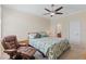 Cozy bedroom featuring floral bedding, a leather recliner, and a ceiling fan at 12565 Canavese Ln, Venice, FL 34293