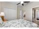 Comfortable bedroom with a closet and view to another room, featuring tropical bedding at 12565 Canavese Ln, Venice, FL 34293