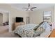 Bright bedroom with floral bedding and a view into the living area at 12565 Canavese Ln, Venice, FL 34293