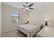 Bright bedroom with ceiling fan, window, neutral paint, and a colorful sea themed comforter at 12565 Canavese Ln, Venice, FL 34293