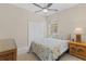 This bedroom has a ceiling fan and seaside-themed decor and has a closet for storage at 12565 Canavese Ln, Venice, FL 34293