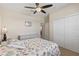 Bright bedroom offering a ceiling fan, closet, and comfortable furnishings, ideal for relaxation at 12565 Canavese Ln, Venice, FL 34293