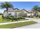 Charming single-story home with a well-manicured lawn and mature palm trees at 12565 Canavese Ln, Venice, FL 34293