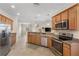Bright kitchen with stainless steel appliances and a breakfast bar overlooking the adjacent living space at 12565 Canavese Ln, Venice, FL 34293