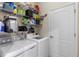 Well-organized laundry room with shelving above new washer and dryer, plus a convenient utility closet at 12565 Canavese Ln, Venice, FL 34293
