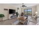 Cozy living room with tile floors, large windows, and a view of the backyard and waterway at 12565 Canavese Ln, Venice, FL 34293