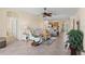 Open-concept living room with tile floors, neutral walls, and comfortable seating at 12565 Canavese Ln, Venice, FL 34293