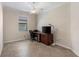 Well-lit office with tile flooring and ceiling fan offers a dedicated workspace at 12565 Canavese Ln, Venice, FL 34293