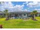 The screened-in backyard features a large pool, beautiful landscaping, and a spacious patio with room for outdoor seating at 13165 Rinella St, Venice, FL 34293