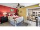 Cozy bedroom featuring bright colors, a ceiling fan, and access to a private balcony at 1555 Tarpon Center Dr # 255, Venice, FL 34285