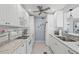Well-lit kitchen with stainless steel appliances, white cabinets, granite counters, and efficient layout at 1555 Tarpon Center Dr # 255, Venice, FL 34285