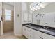 Bathroom with a shower stall, granite counters, dual sinks, and decorative wall art at 1572 Monarch Dr, Venice, FL 34293