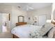 Cozy bedroom featuring a decorative ceiling fan, light walls, and nautical-themed bedding and decor at 1572 Monarch Dr, Venice, FL 34293