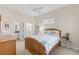 Bright bedroom features a door to the bathroom and walk-in closet with wooden furniture at 1572 Monarch Dr, Venice, FL 34293