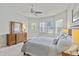 Comfortable bedroom with a wooden dresser and a large bed, illuminated by bedside lamps at 1572 Monarch Dr, Venice, FL 34293