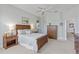 Bright bedroom with neutral walls, wooden furniture, and an ensuite bathroom access at 1572 Monarch Dr, Venice, FL 34293