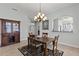 Dining room featuring a chandelier and furniture set on a patterned rug at 1572 Monarch Dr, Venice, FL 34293