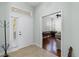 Entryway with neutral colored flooring, leading to a brightly lit living room with hardwood floors at 1572 Monarch Dr, Venice, FL 34293