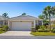 Charming single-story home featuring a two-car garage and well-manicured landscaping at 1572 Monarch Dr, Venice, FL 34293