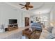 Open living room with tile flooring, a ceiling fan, neutral paint, and entry to dining room at 1572 Monarch Dr, Venice, FL 34293