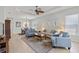Inviting living room featuring tile flooring, a ceiling fan, neutral paint, and ample natural light at 1572 Monarch Dr, Venice, FL 34293
