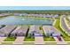 Stunning aerial view of homes lining a community pond with a central fountain feature at 1606 Cedar Valley Dr, Port Charlotte, FL 33953