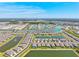 Vast aerial view of a well-planned community interspersed with tranquil lakes and lush greenery at 1606 Cedar Valley Dr, Port Charlotte, FL 33953